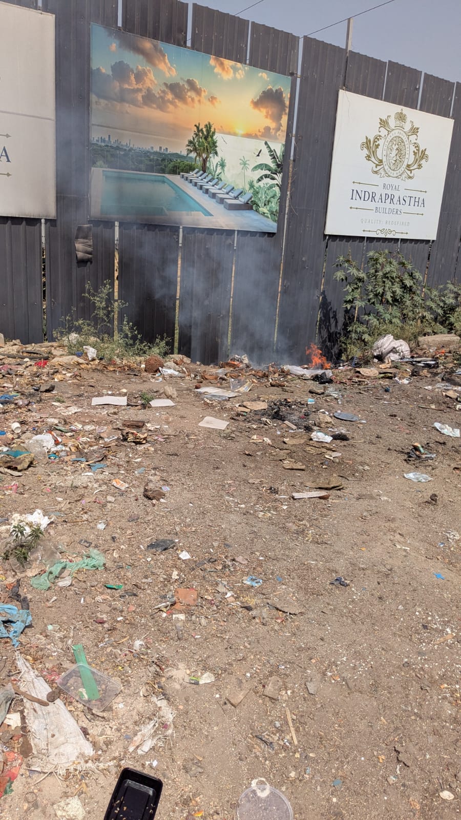 Actively burning trash near Roya Indraprastha Builders site